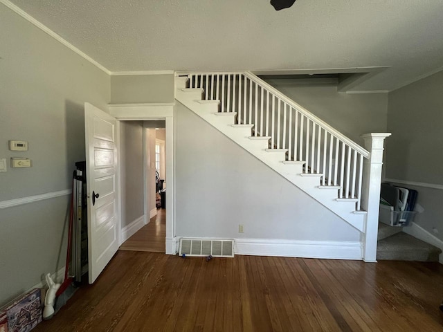 201 Bonito St, Walworth, WI 53184 - stairs featuring crown molding, baseboards, visible vents, and wood-type flooring