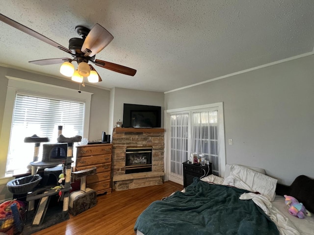 201 Bonito St, Walworth, WI 53184 - bedroom featuring wood finished floors, a textured ceiling, and a fireplace
