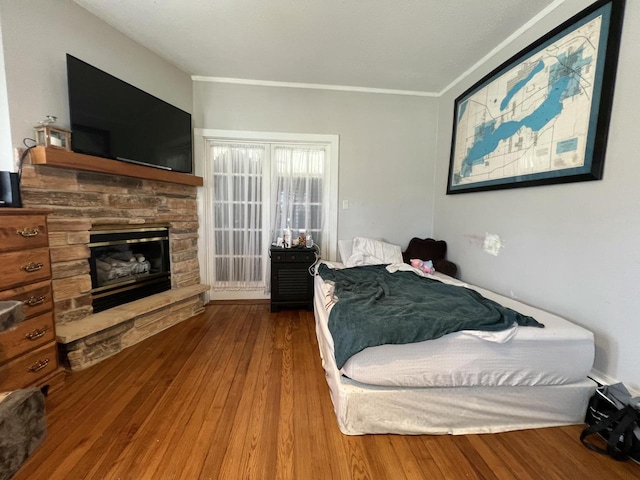 201 Bonito St, Walworth, WI 53184 - bedroom with a stone fireplace, wood finished floors, and crown molding