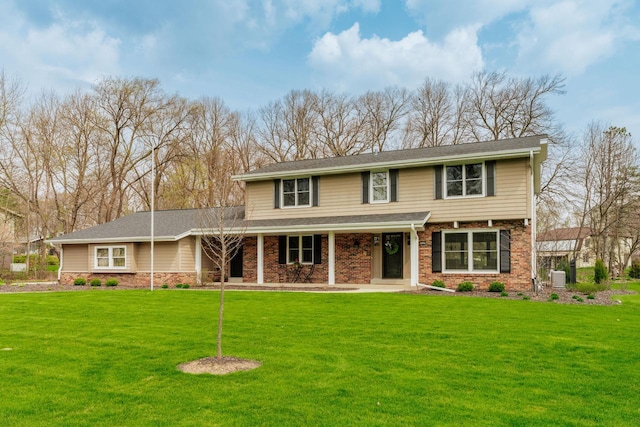 traditional-style house with a porch, a front yard, and central AC unit