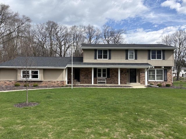 traditional-style home featuring a front yard and brick siding