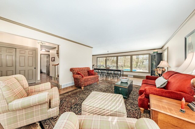 living area with baseboards and ornamental molding