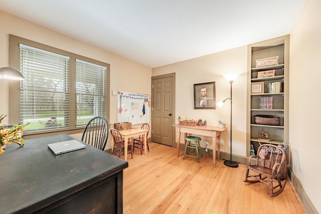 home office featuring light wood-style floors and baseboards