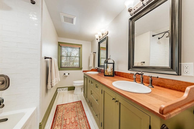 bathroom with tub / shower combination, visible vents, double vanity, and a sink