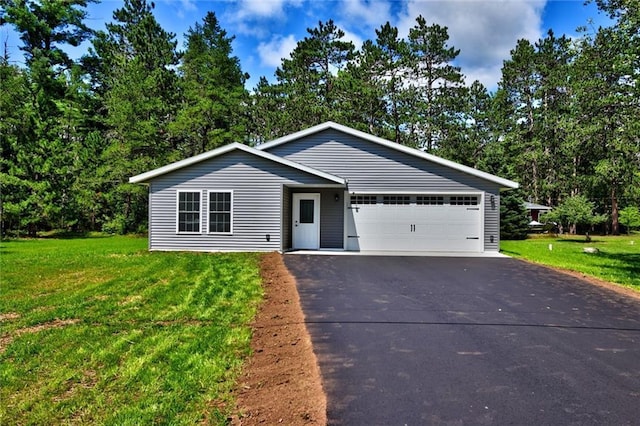 10230 Olker Rd, Hayward, WI 54843 - view of front of home with driveway, a garage, and a front yard