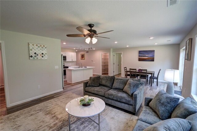 10230 Olker Rd, Hayward, WI 54843 - living room with visible vents, light wood-style flooring, baseboards, and ceiling fan