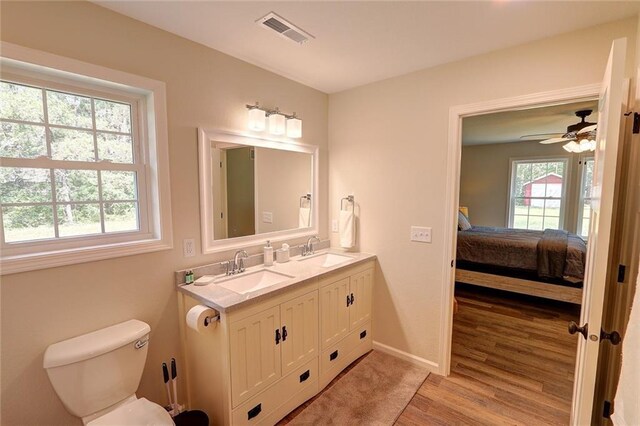 10230 Olker Rd, Hayward, WI 54843 - ensuite bathroom featuring toilet, a sink, visible vents, and ensuite bathroom