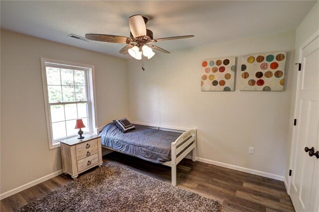 10230 Olker Rd, Hayward, WI 54843 - bedroom with dark wood finished floors, baseboards, ceiling fan, and visible vents