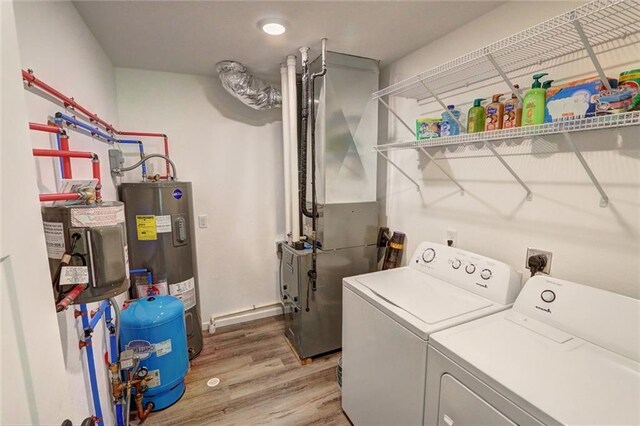 10230 Olker Rd, Hayward, WI 54843 - washroom with water heater, heating unit, laundry area, independent washer and dryer, and light wood-style floors