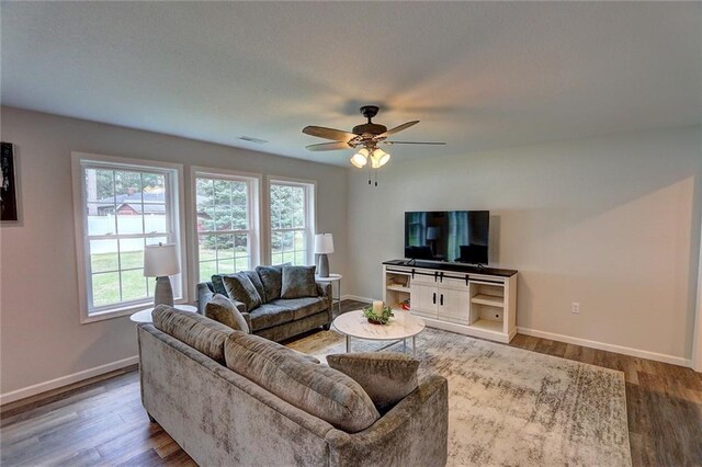 10230 Olker Rd, Hayward, WI 54843 - living room with wood finished floors, visible vents, baseboards, and ceiling fan
