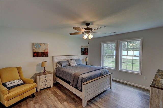 10230 Olker Rd, Hayward, WI 54843 - bedroom featuring baseboards, a ceiling fan, wood finished floors, and visible vents