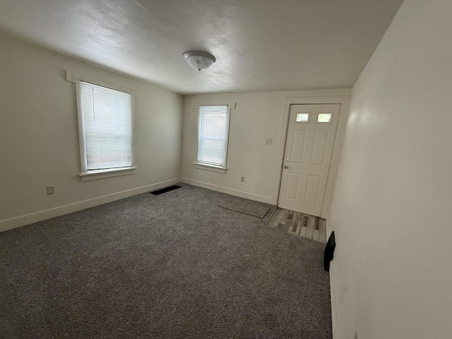 1921 S Wisconsin Ave, Beloit, WI 53511 - foyer with baseboards and dark carpet