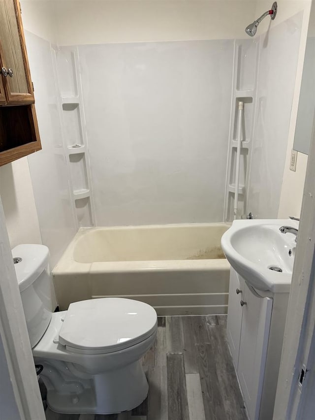 1921 S Wisconsin Ave, Beloit, WI 53511 - bathroom with toilet, wood finished floors, vanity, and shower / bathtub combination
