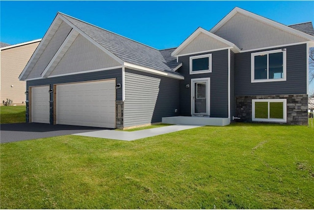 30410 72nd Avenue Way, Cannon Falls, MN 55009 - view of front of property featuring a front lawn, aphalt driveway, stone siding, and a garage
