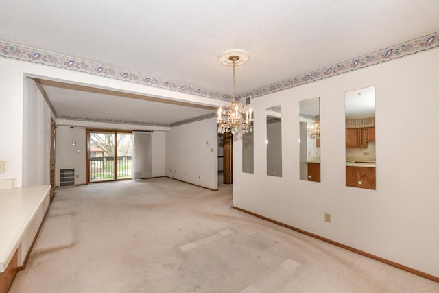 carpeted empty room with baseboards and an inviting chandelier