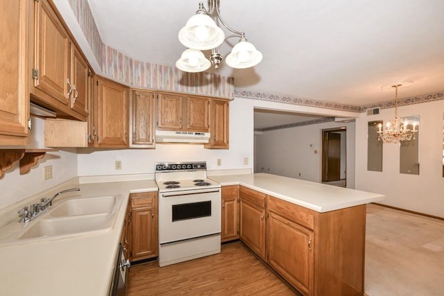 kitchen featuring a sink, under cabinet range hood, white electric range, a peninsula, and a notable chandelier