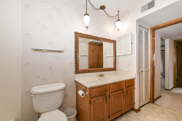 bathroom featuring wallpapered walls, toilet, vanity, and visible vents
