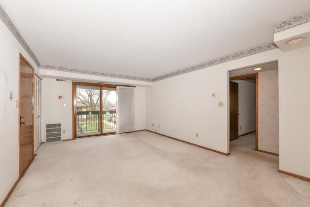 spare room with visible vents, baseboards, and light colored carpet