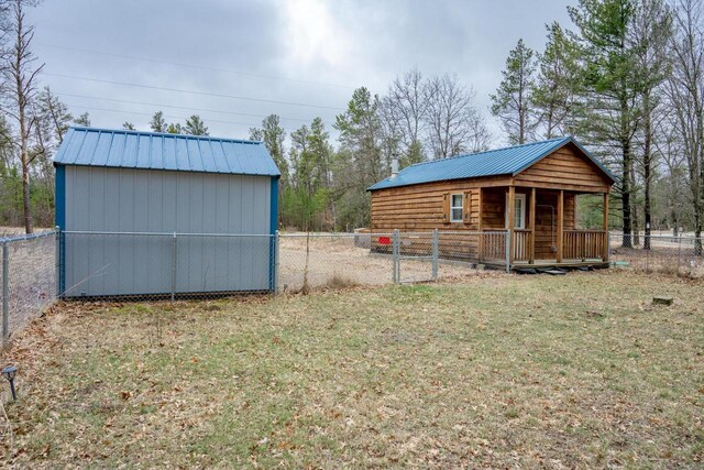 W4742 26th St, Necedah, WI 54646 - view of shed with a gate, a fenced backyard, and covered porch