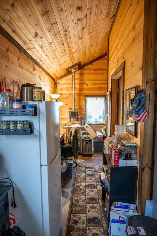 W4742 26th St, Necedah, WI 54646 - interior space with freestanding refrigerator, vaulted ceiling, wood ceiling, and wooden walls