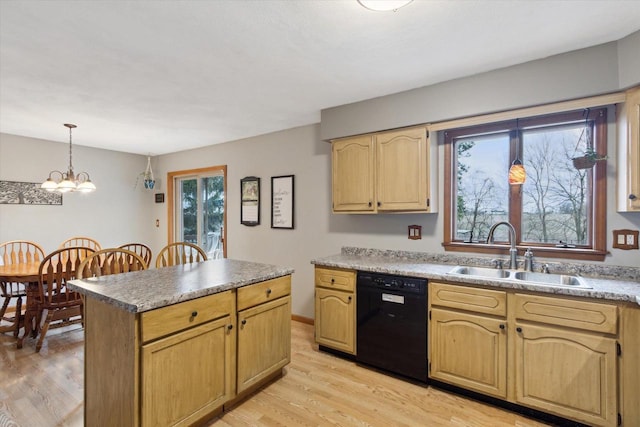 kitchen featuring dishwasher, hanging light fixtures, a sink, and light wood-type flooring