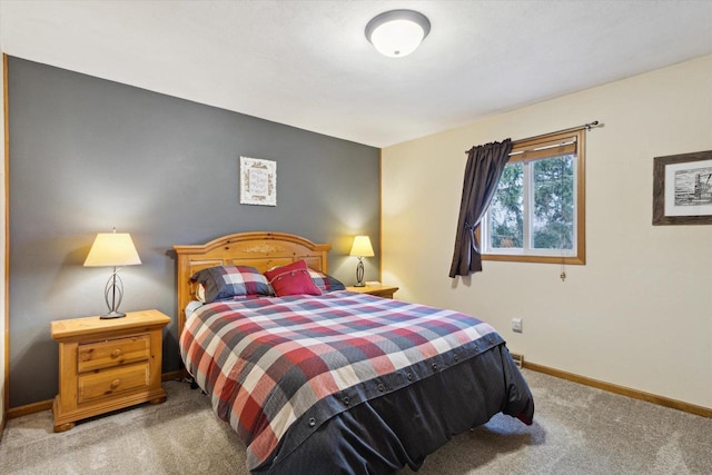 carpeted bedroom featuring baseboards
