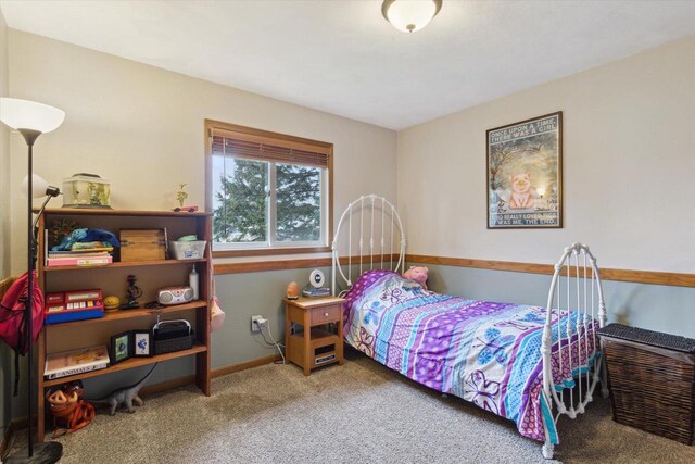 carpeted bedroom featuring baseboards