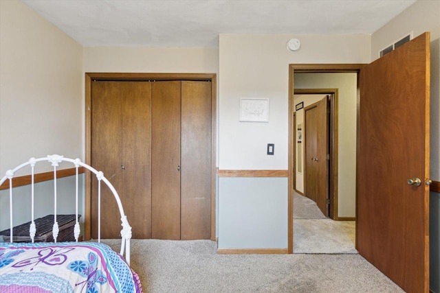 carpeted bedroom with a closet