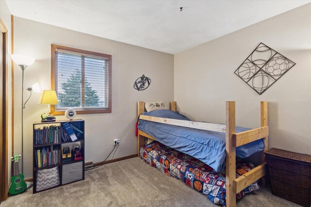 bedroom with carpet floors and baseboards