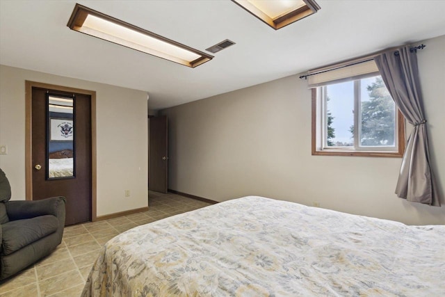 tiled bedroom with baseboards and visible vents