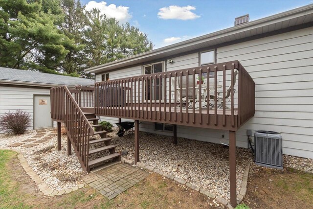 back of house with central AC, a wooden deck, and stairway