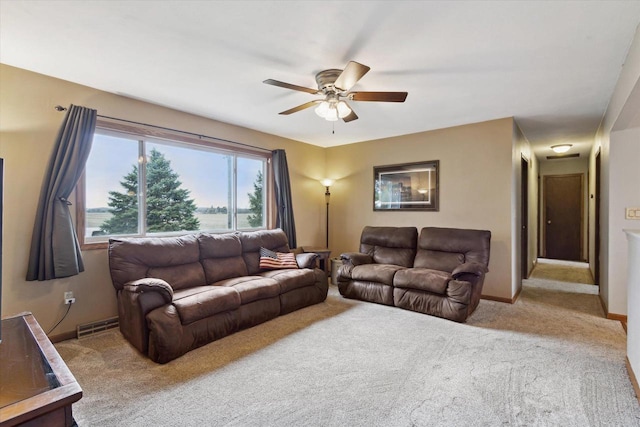 living area with baseboards, a ceiling fan, visible vents, and carpet
