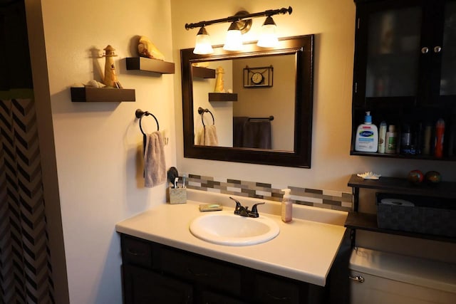 2282 Collier Ct, Green Bay, WI 54311 - bathroom featuring vanity, toilet, and tasteful backsplash