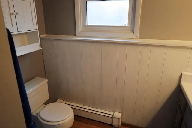 2282 Collier Ct, Green Bay, WI 54311 - bathroom with a baseboard heating unit, a wainscoted wall, toilet, and a decorative wall
