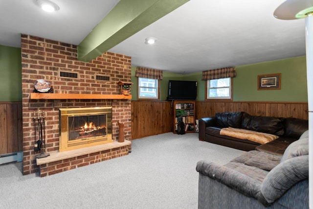 2282 Collier Ct, Green Bay, WI 54311 - carpeted living room featuring wainscoting, wooden walls, a fireplace, and a baseboard heating unit