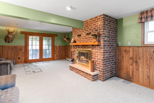 2282 Collier Ct, Green Bay, WI 54311 - unfurnished living room with wainscoting, wood walls, carpet, a brick fireplace, and beamed ceiling