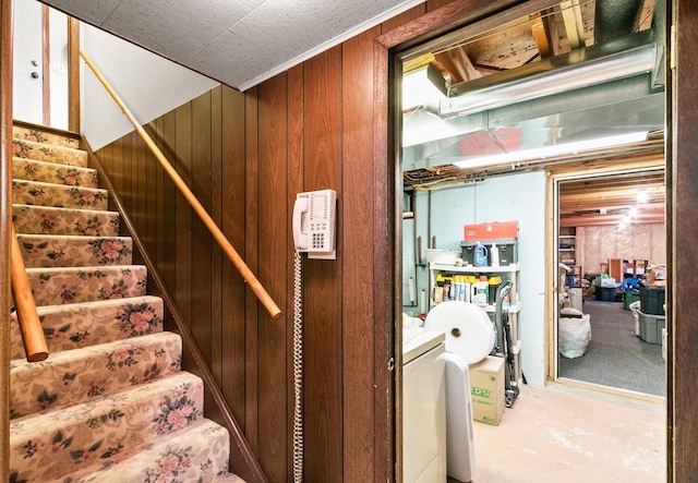 staircase featuring wood walls