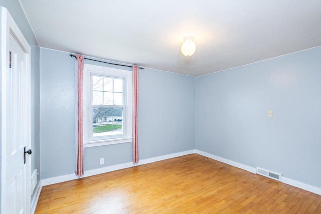 414 State Road 26, Oshkosh, WI 54904 - spare room featuring baseboards, light wood finished floors, and visible vents