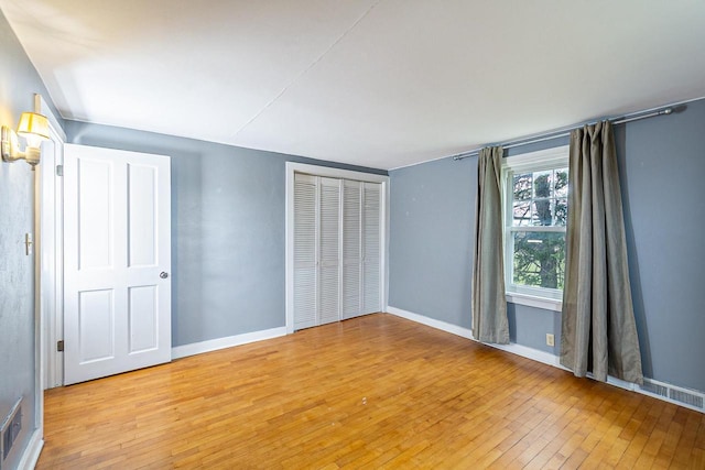 414 State Road 26, Oshkosh, WI 54904 - unfurnished bedroom with baseboards and light wood-type flooring