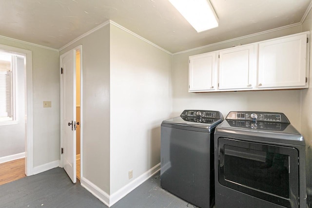 414 State Road 26, Oshkosh, WI 54904 - clothes washing area featuring baseboards, cabinet space, separate washer and dryer, wood finished floors, and crown molding