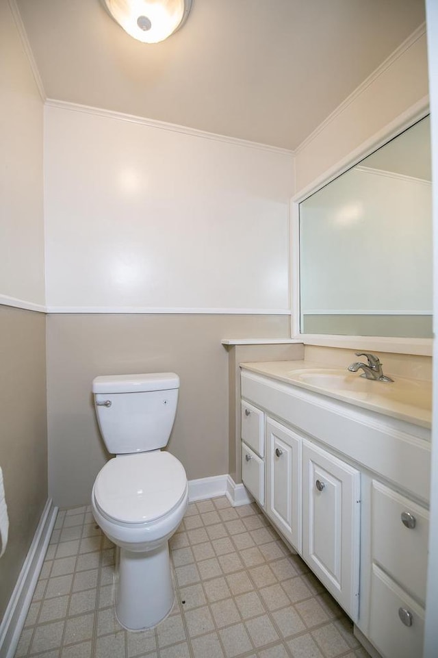 414 State Road 26, Oshkosh, WI 54904 - bathroom with tile patterned floors, vanity, baseboards, toilet, and ornamental molding