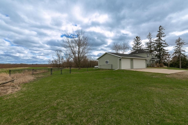 414 State Road 26, Oshkosh, WI 54904 - view of yard featuring fence, an attached garage, and concrete driveway