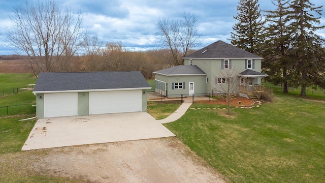 414 State Road 26, Oshkosh, WI 54904 - view of front of house with fence, an outbuilding, a detached garage, and a front yard
