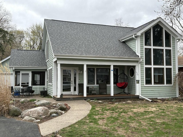 141 W Park Dr, Twin Lakes, WI 53181 - rear view of house featuring roof with shingles and covered porch