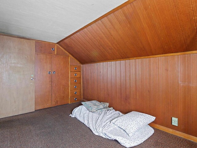 1802 S Ridge Rd, Green Bay, WI 54304 - unfurnished bedroom featuring vaulted ceiling, wood walls, and carpet flooring