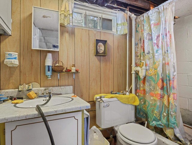 1802 S Ridge Rd, Green Bay, WI 54304 - bathroom with curtained shower, wood walls, concrete block wall, toilet, and vanity