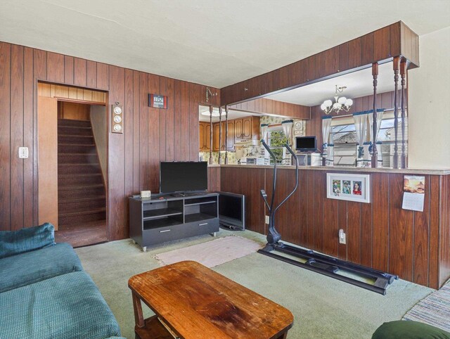 1802 S Ridge Rd, Green Bay, WI 54304 - living room with stairs, wooden walls, carpet, and a notable chandelier