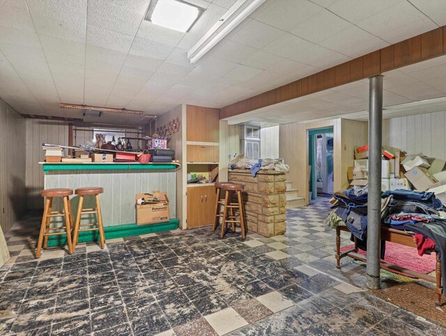 1802 S Ridge Rd, Green Bay, WI 54304 - finished below grade area with a bar, tile patterned floors, and wooden walls