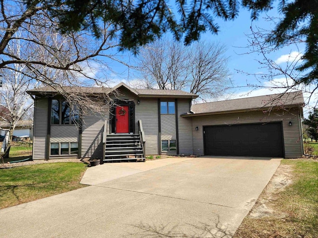 12902 Flicker Rd, Tomah, WI 54660 - view of front of house featuring an attached garage, a front lawn, and concrete driveway