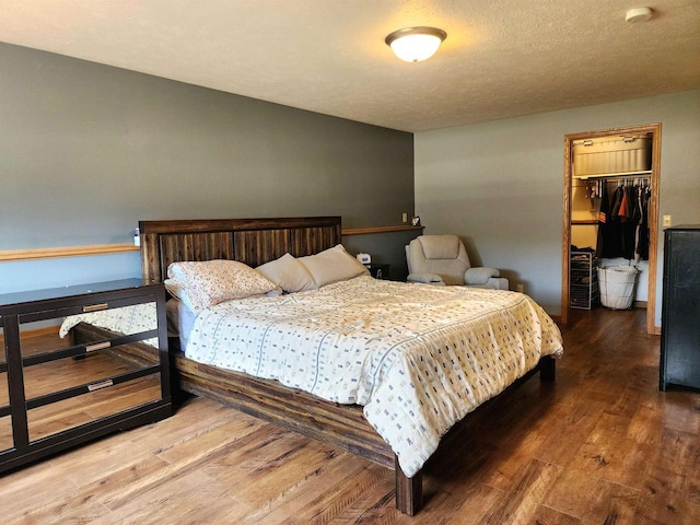 12902 Flicker Rd, Tomah, WI 54660 - bedroom with wood finished floors, a spacious closet, and a closet